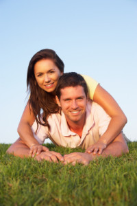Young couple posing on a field
